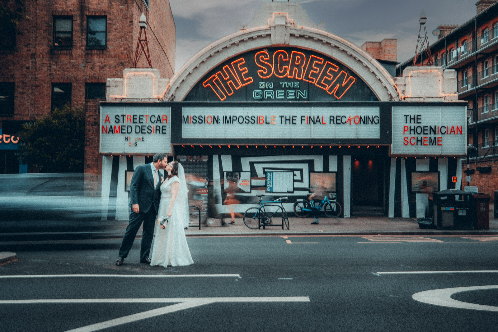 Street wedding portrait outside a cinema