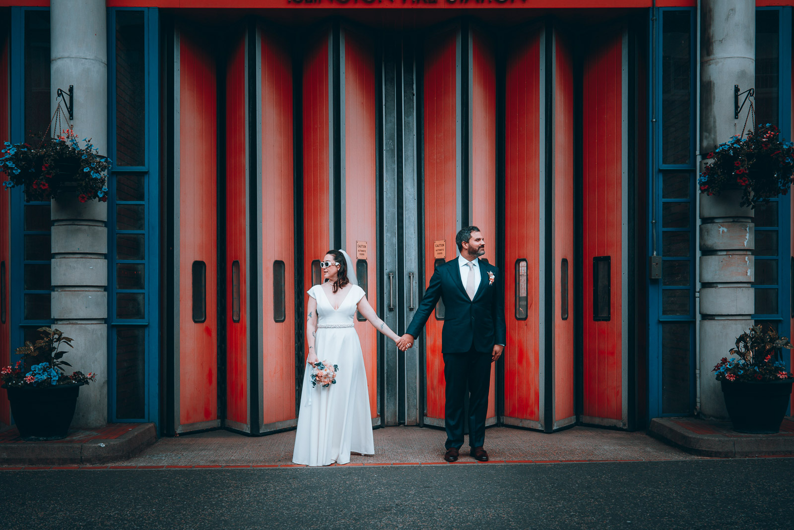 Street wedding portrait against red doors